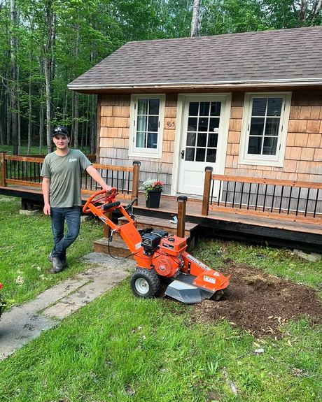 Logan Steeves, owner of Steeves Stump Services, with his stump grinder at a home near Moncton, NB